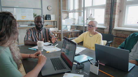 group of diverse colleagues having business meeting in office