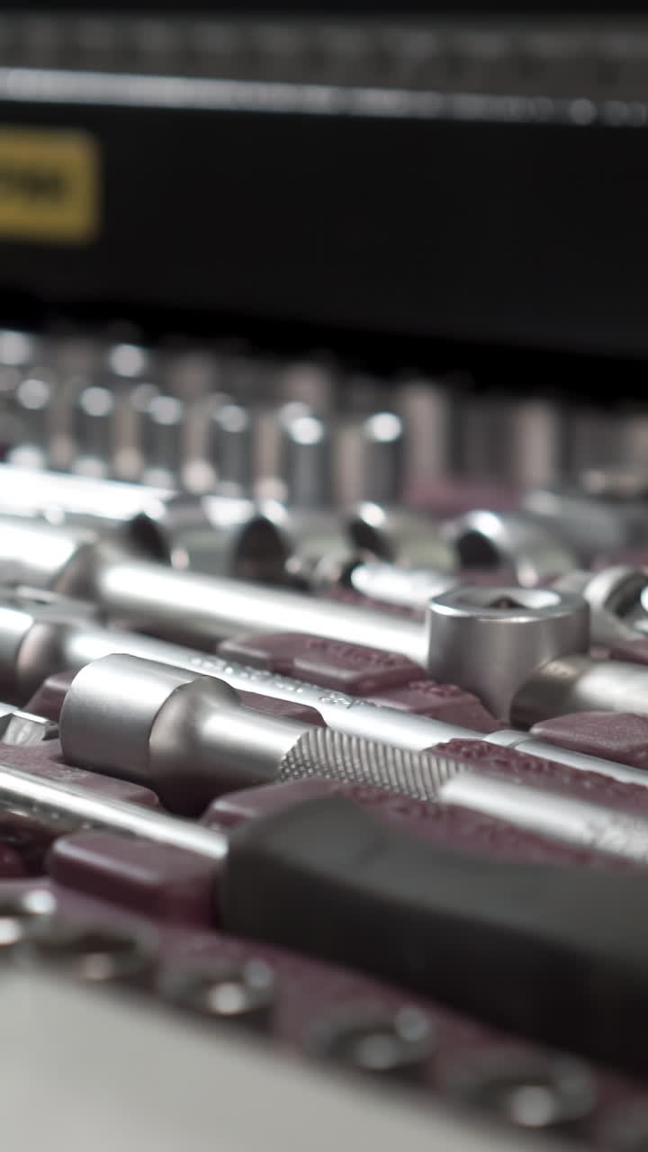 Close-up of hand reaching into box of tools