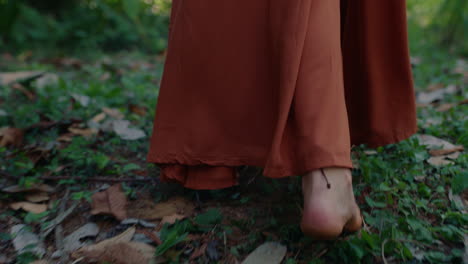 close up barefoot woman walking in forest exploring lush tropical jungle alone 4k