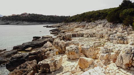 Rocky-Beach-Of-Paralia-Emplisi-In-Greece---aerial-shot