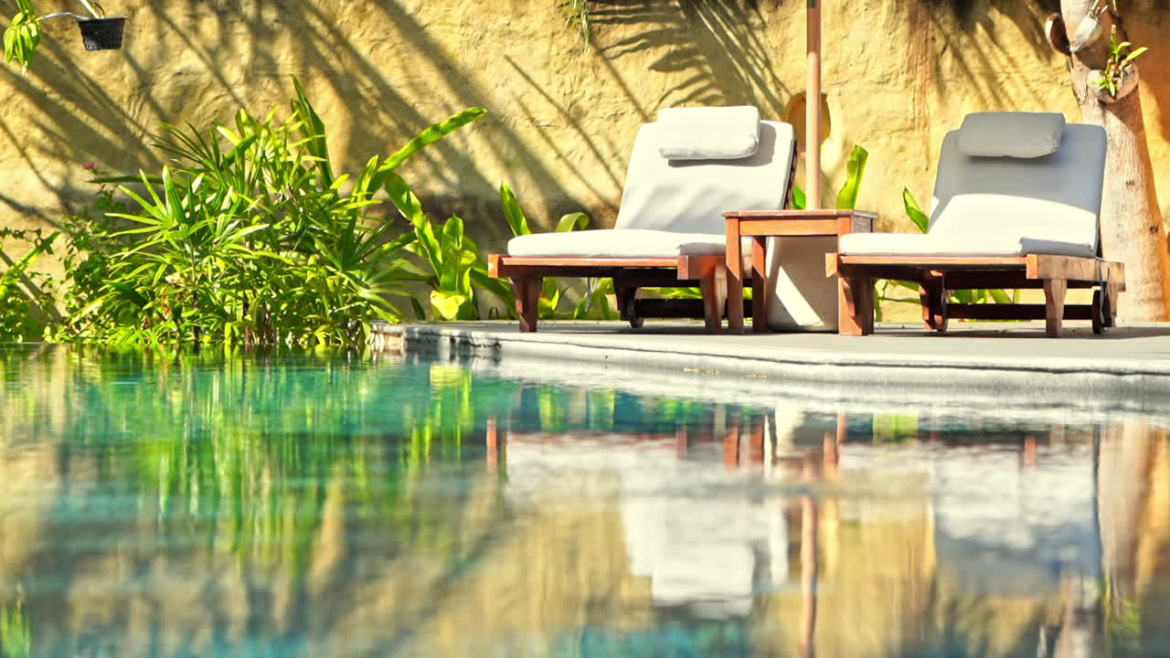 Two Empty deck chairs near the swimming pool