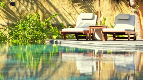 two empty deck chairs near the swimming pool