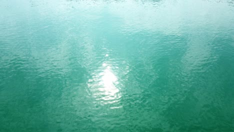 aerial top-down view of the sea surface with deep blue water, moving forward