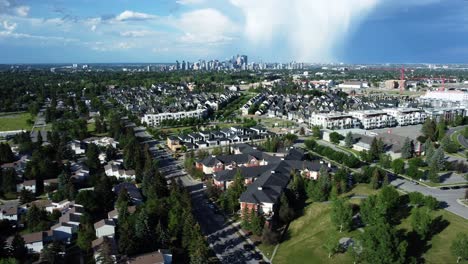 drone side shot of downtown calgary in summertime with rainy clouds