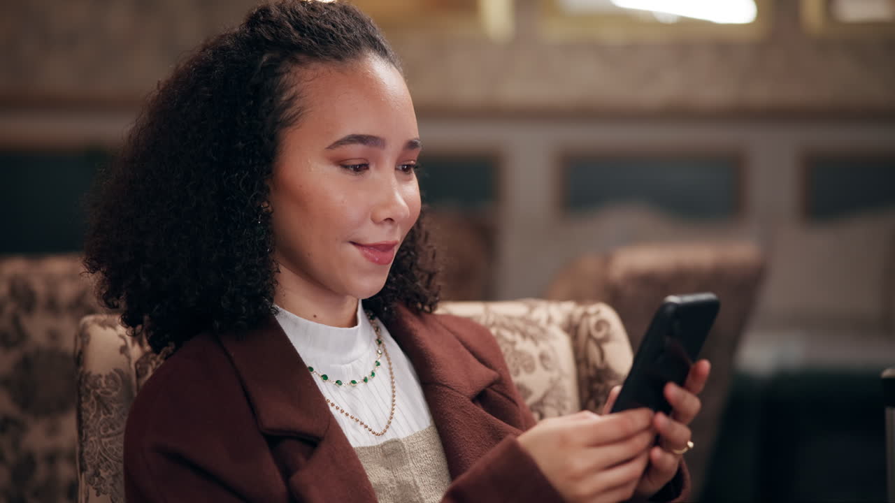 Woman using mobile phone indoors