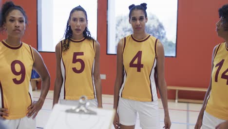 happy diverse female basketball team training in indoor court, in slow motion