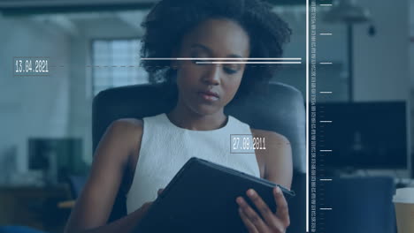 animation of data processing over african american businesswoman using digital tablet at office