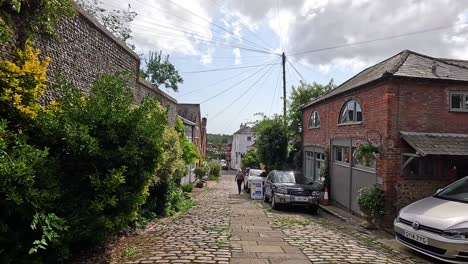 people walking down a cobblestone alley