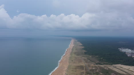 La-digue-sandy-beach-along-pine-forests-aerial-shot-Basque-coast-France-cloudy