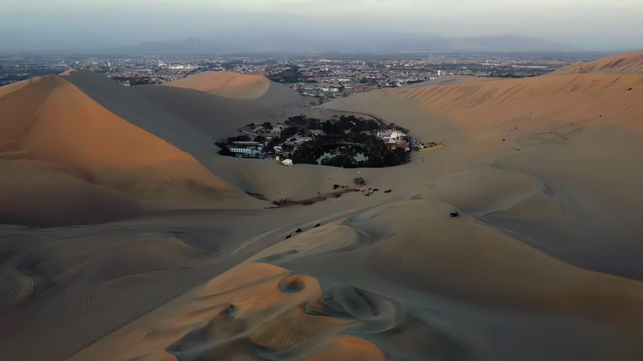 Huacachina desert oasis village Peru around sand dunes South America aerial drone