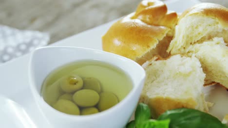 Pickled olives, herb and pieces of bread