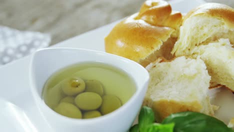 pickled olives, herb and pieces of bread