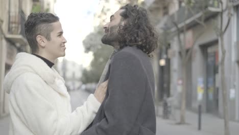 Two People Embracing and Laughing in the City
