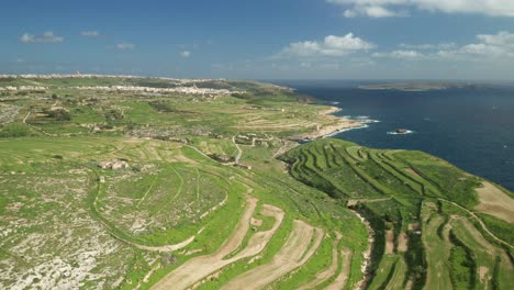 aerial: ta cenc cliffs being washed by blue mediterranean sea on windy winter day