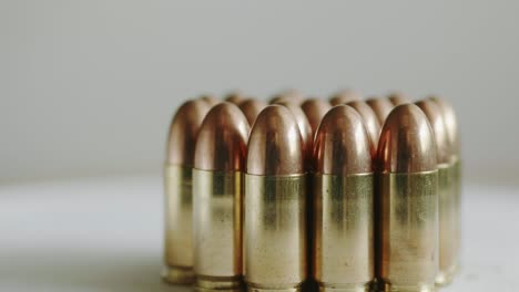 close up of many ammunition are arranged in a row and rotated with a rotating platform