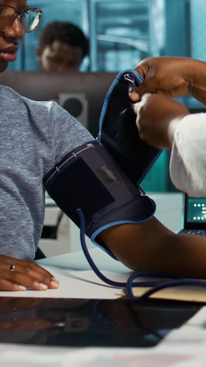 Medical Professional Measuring Patient's Blood Pressure in Clinic