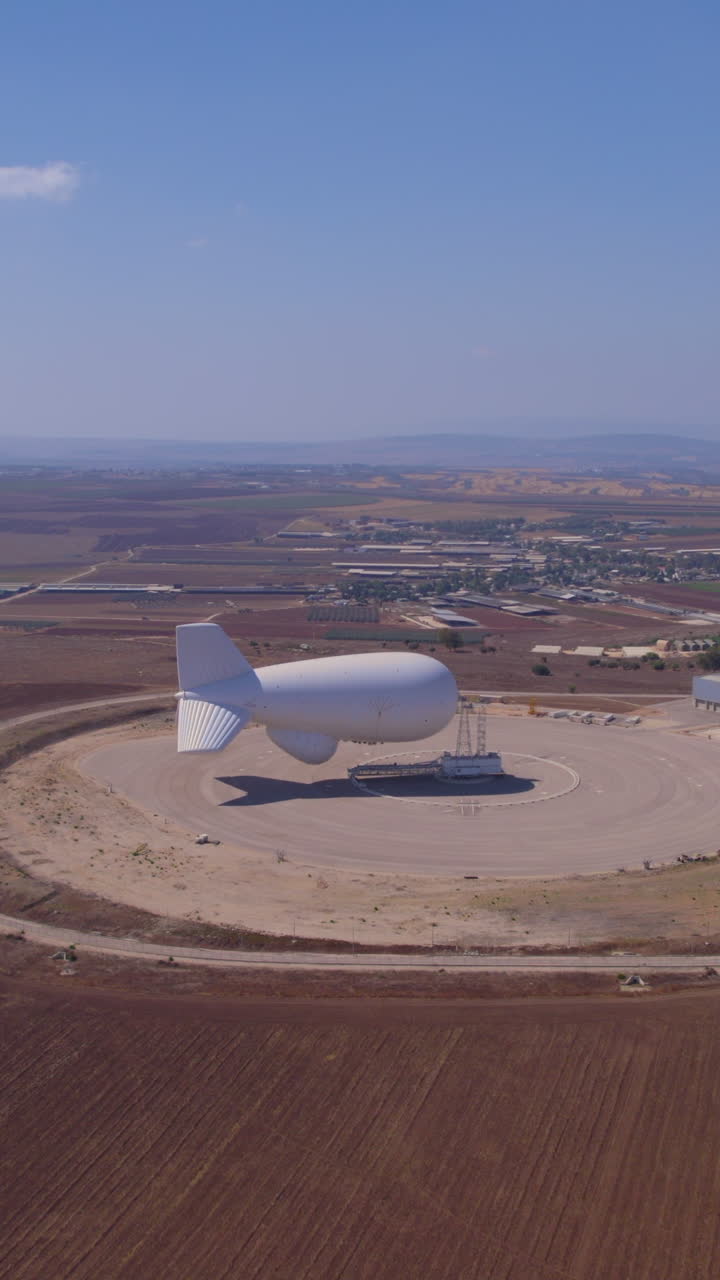 Zeppelin balloon conducts mass surveillance with vertical video to collect real-time weather data and atmospheric conditions