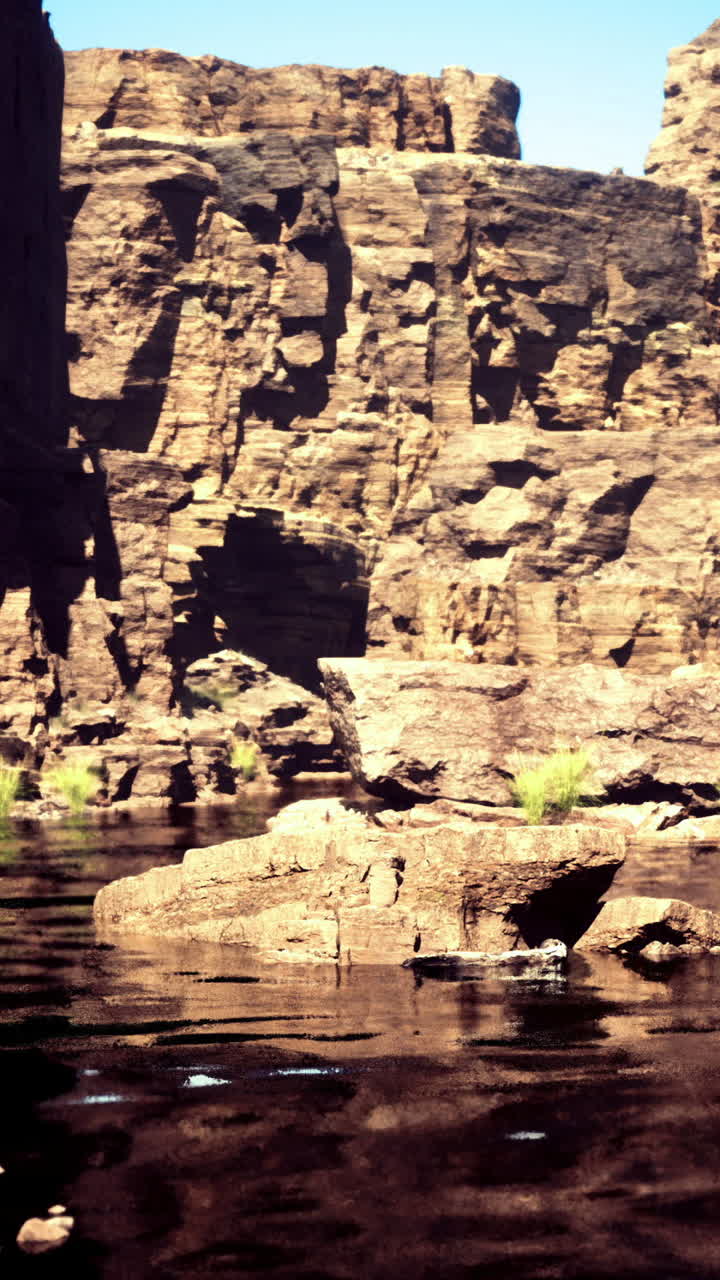 Majestic canyon with serene waters reflecting the clear blue sky