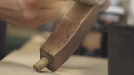 man painting piece of furniture