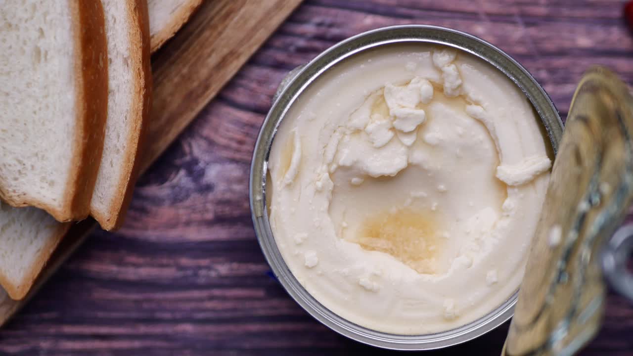 Open Can of Condensed Cream with Bread