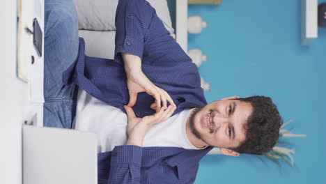 Vertical-video-of-Man-making-heart-symbol-for-camera.