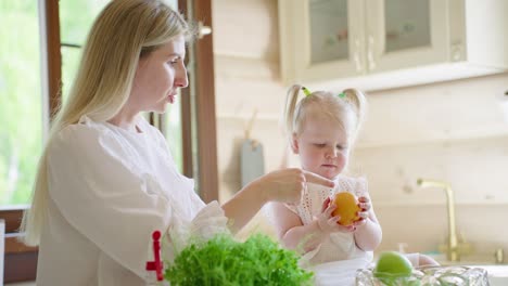 mother and daughter preparing fruits in the kitchen