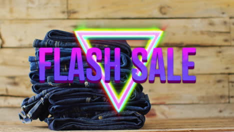 animation of flash sale text over denim trousers on wooden background