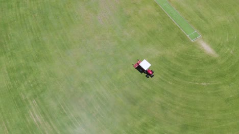 tractor mowing a sports field in circles