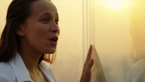 slow motion shot of a female tourist smiling and pointing at the bangkok cityscape