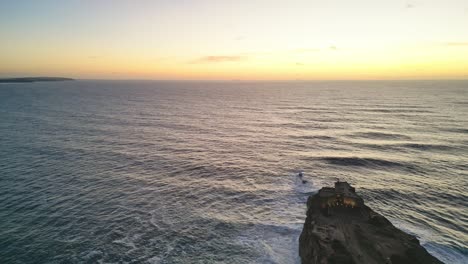 golden hour view of nazare's lighthouse perched over the atlantic ocean