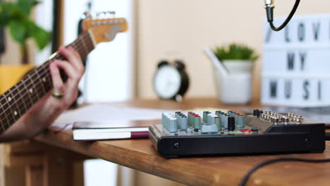 young man practising with the guitar