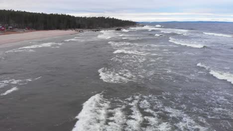 cold foamy waves of baltic sea coming into swedish coastline - aerial