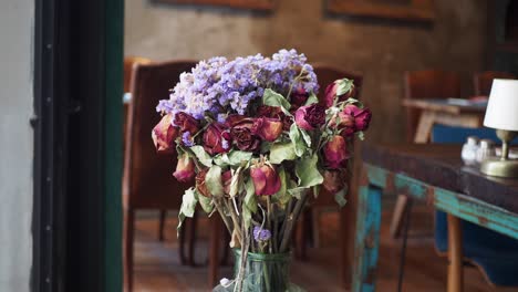 dried roses in vintage vase