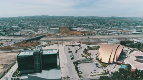 Aerial-shot-of-Tijuana-city-going-over-a-freeway-with-cars