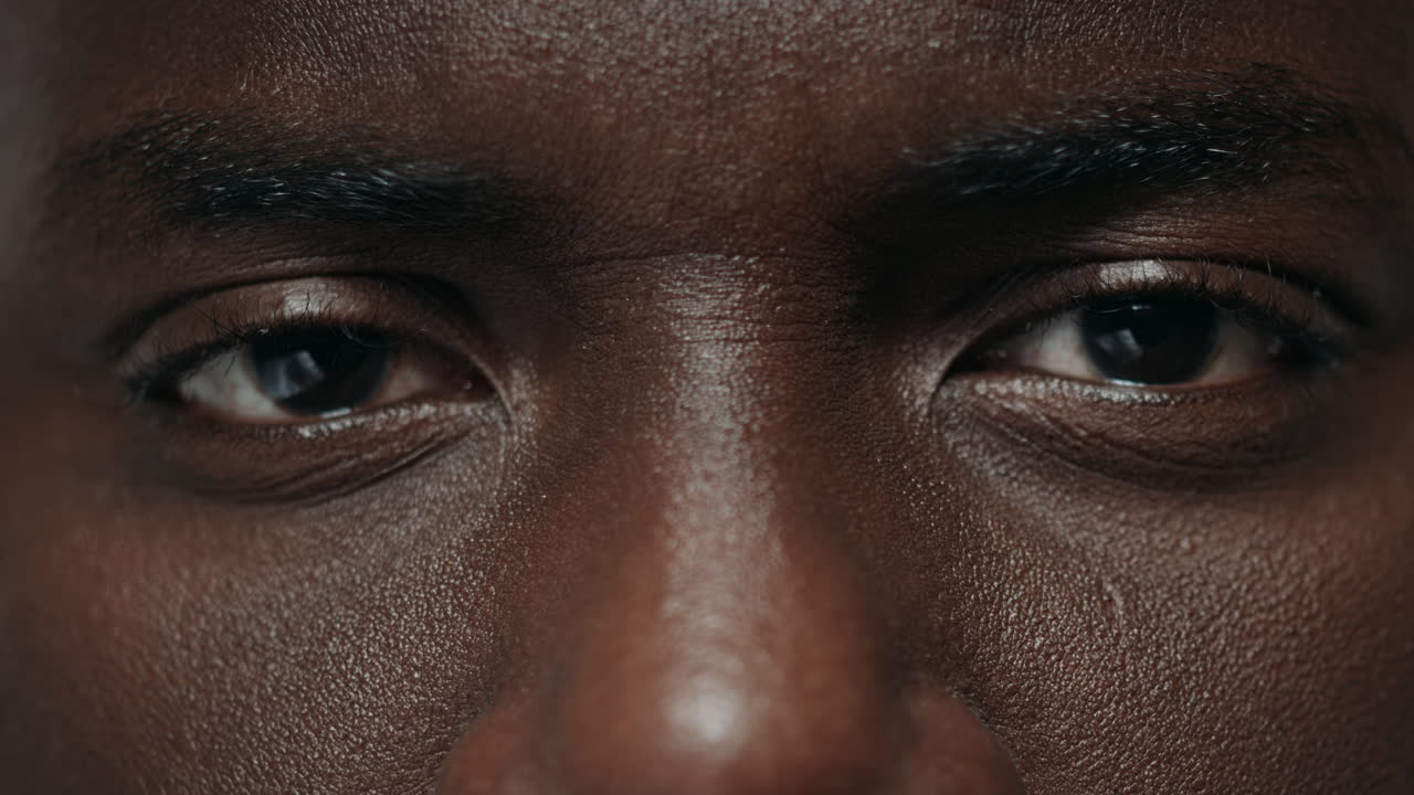 Extreme closeup african american man looking at camera. African guy face