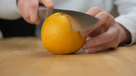 cutting an orange in pieces