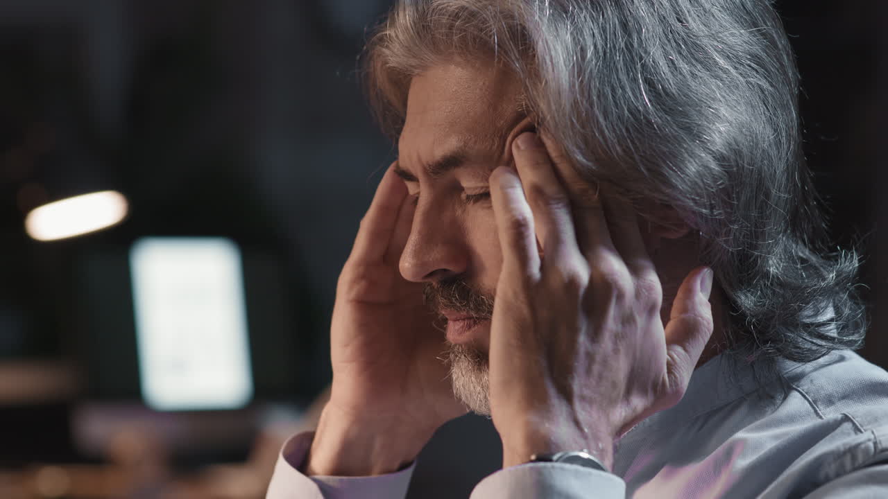 Mature Man Suffering from Headache or Stress at Work