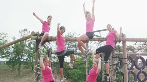 Female-friends-enjoying-exercising-at-boot-camp-together