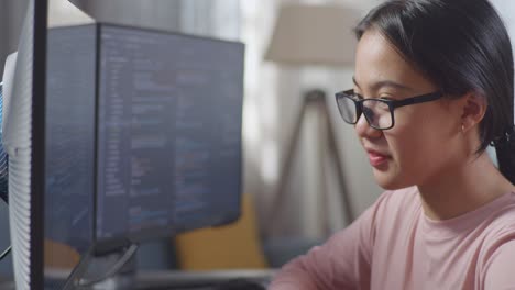 Woman working on a computer with a happy expression