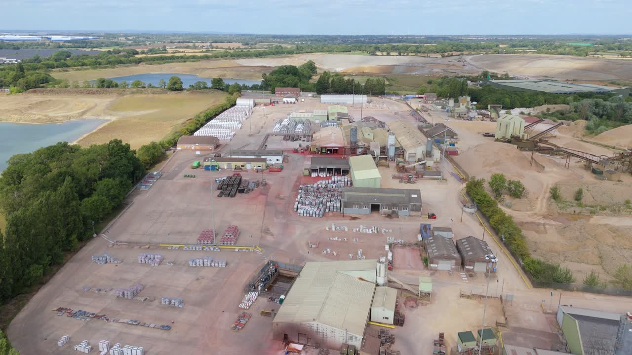 Industrial aggregates warehouses and storage sites aerial drone shot Rugby England UK construction hub