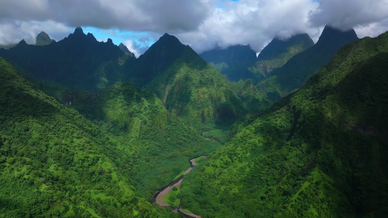 Teahupoo Vallee de Tautira River Valley Bay Vaitepiha village Tahiti island French Polynesia aerial drone jagged mountain Aorai peak canyon Aorai Taiarapu Taravao North Shore sunny clouds static shot