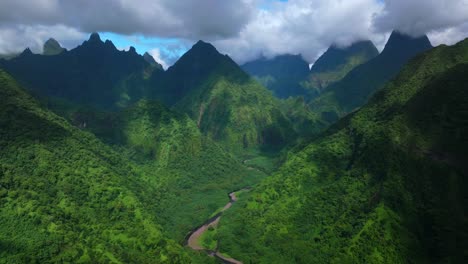 teahupoo vallee de tautira river valley bay vaitepiha village tahiti island french polynesia aerial drone jagged mountain aorai peak canyon aorai taiarapu taravao north shore sunny clouds static shot
