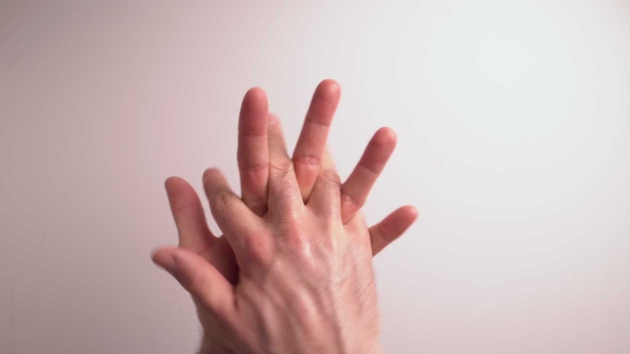 Legally advised hand sanitising technique presentation followed by NHS guidelines.  Hand sanitising gel has been applied to a white man's hand