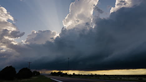 crepuscular rays fill the sky as a powerful storm builds overhead
