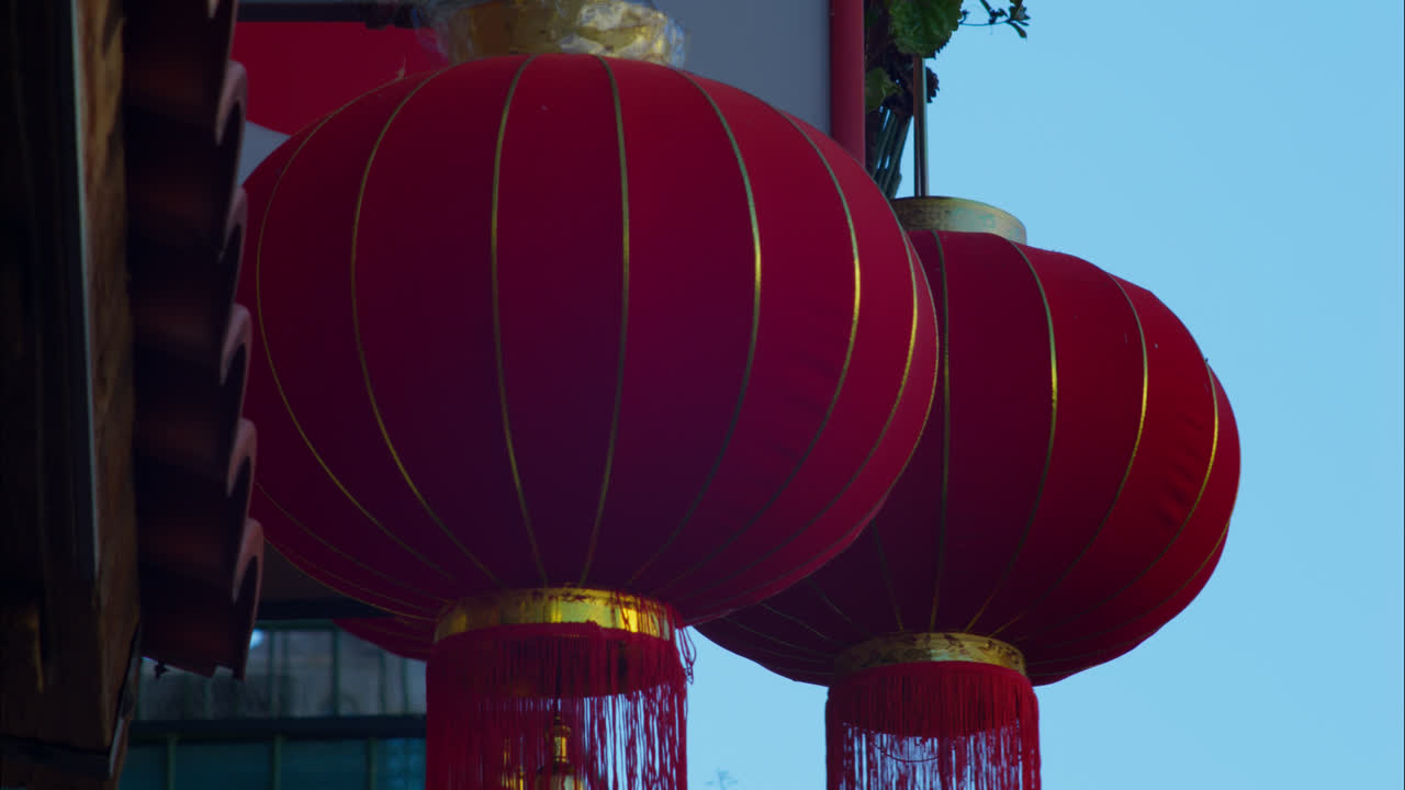 Red Chinese Lanterns Swaying Gently Against a Blue Sky | Premium Stock ...