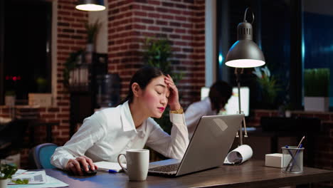 office employee sighing in frustration, feeling overworked