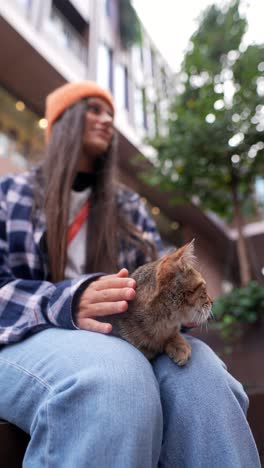 teenage girl with cat in urban setting