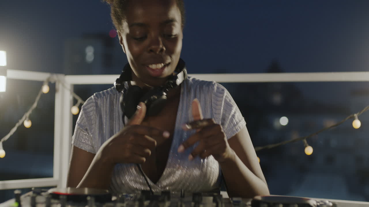 Woman DJing on Rooftop at Night