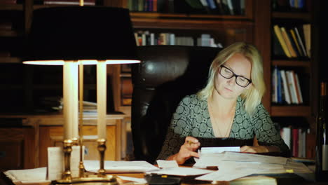 businesswoman works at desk at night