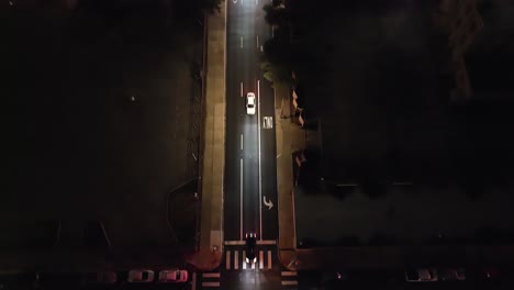 fort worth, texas traffic intersection at night with drone video tilting up